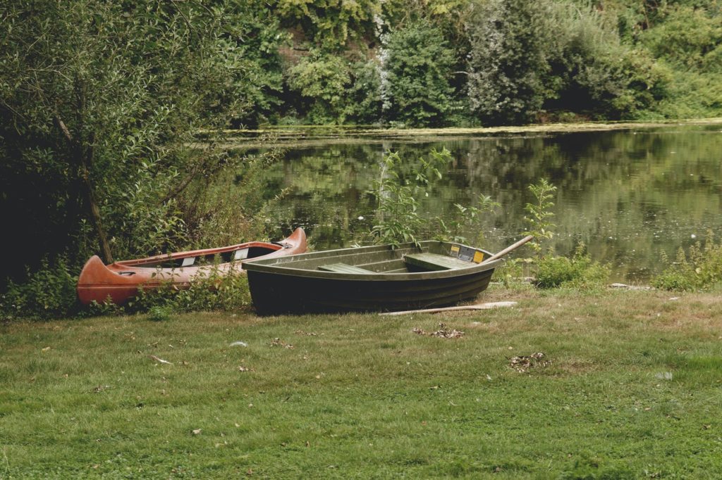 Recreational boats on the bank of a lake representing the need to exercise caution when boating to avoid accidents