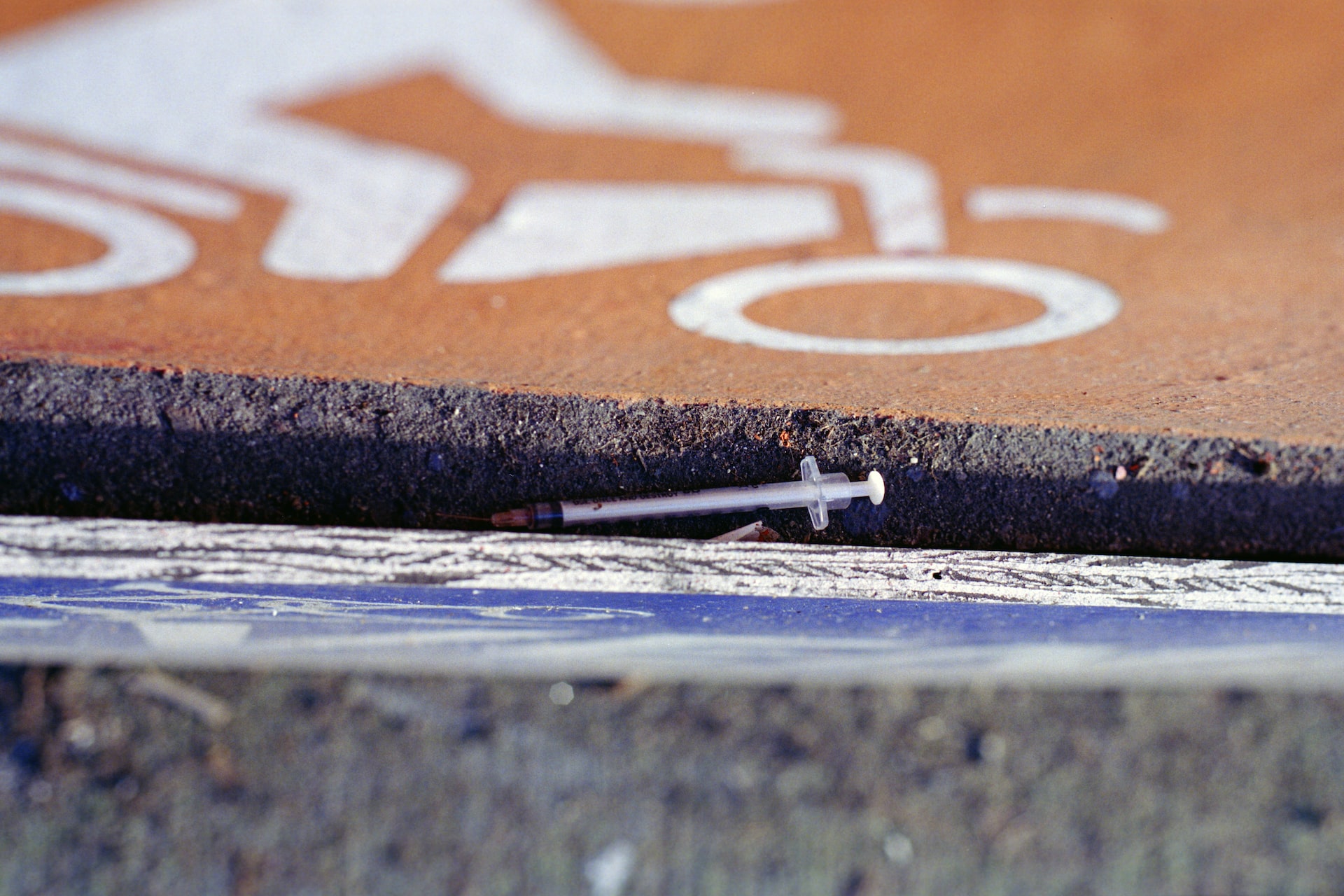 A needle laying on a street gutter, representing the public interest in enforcing drug trafficking offences.