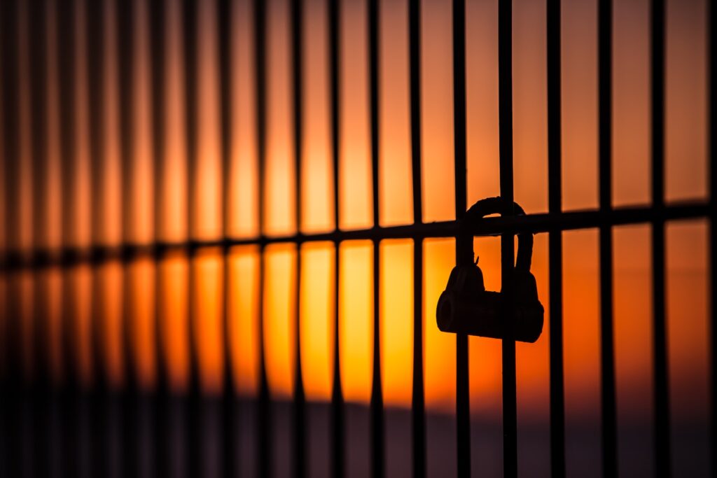 silhouette of jail bars at sunrise