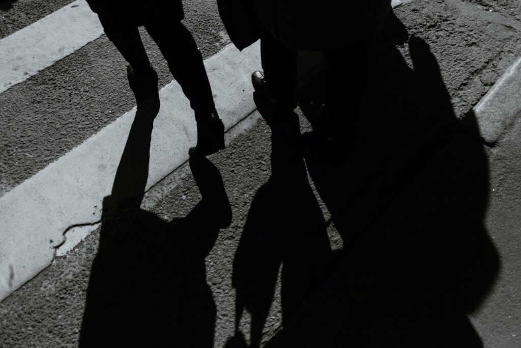 Silhouette of multiple people at a crosswalk, representing parties to an offence, aiding and abetting, and accessory after the fact in Ontario