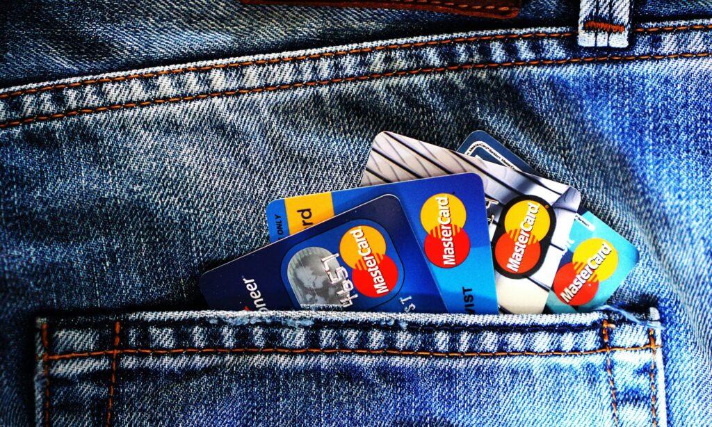Several credit cards in the back pocket of someone's jeans, representing fraud charges in Ontario