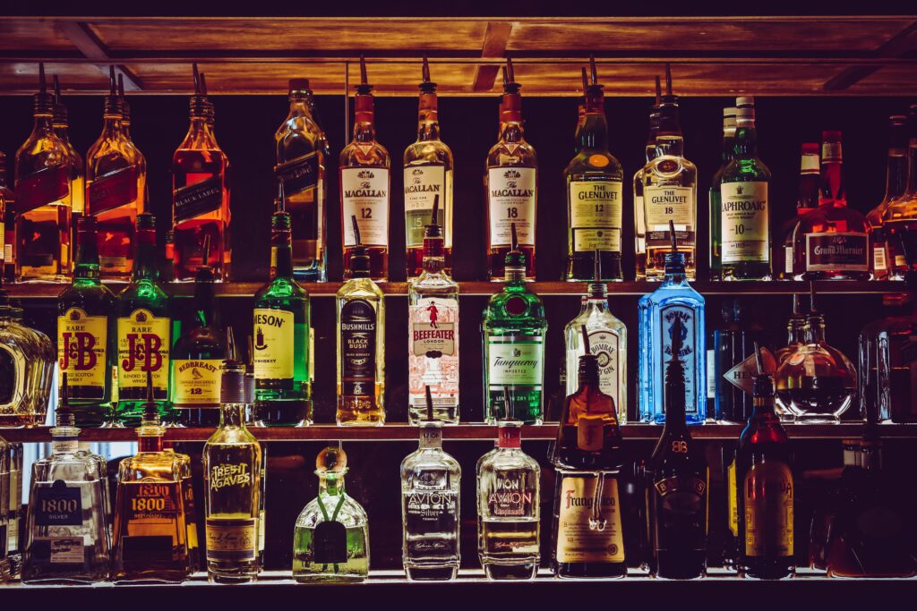 Liquor bottles on a shelf representing liquor license violations