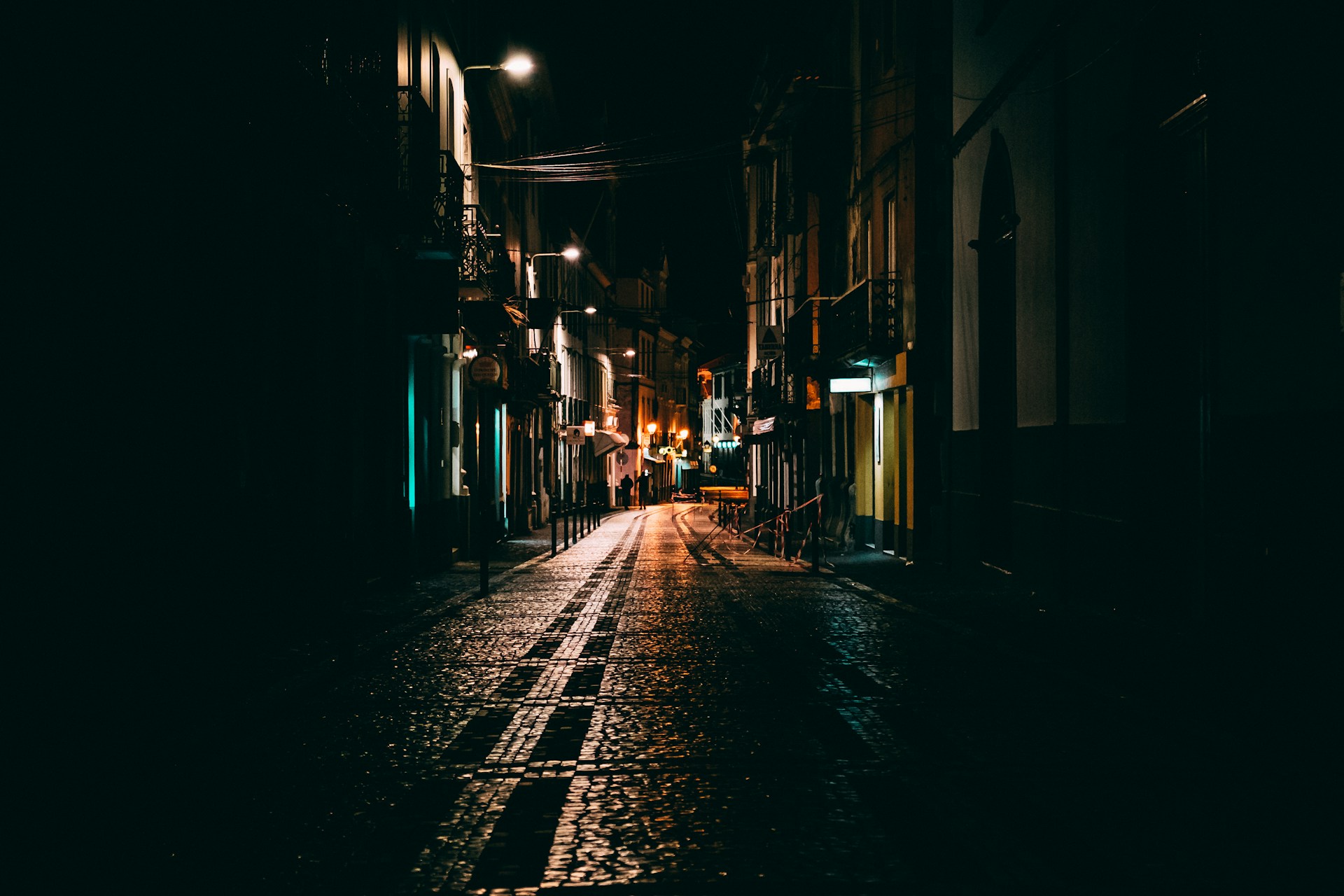View of window lights down a darkened city alley, representing illegal massage parlours and criminal appeals