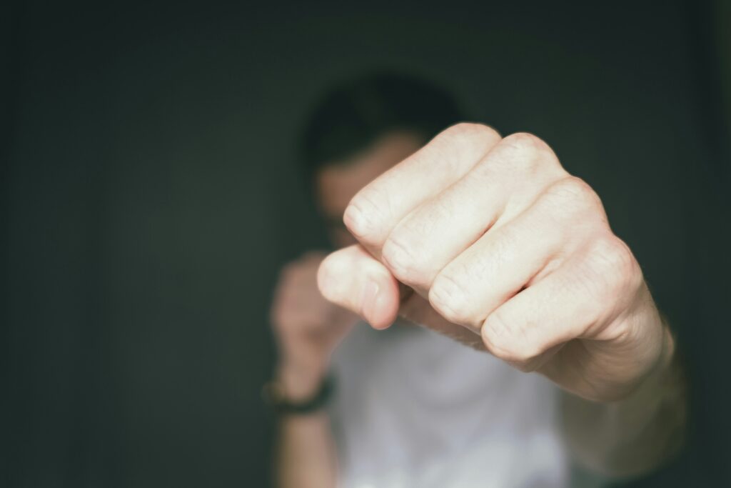 Close-up of a man's fist punching toward the camera, representing the right to self-defence in Canadian criminal law