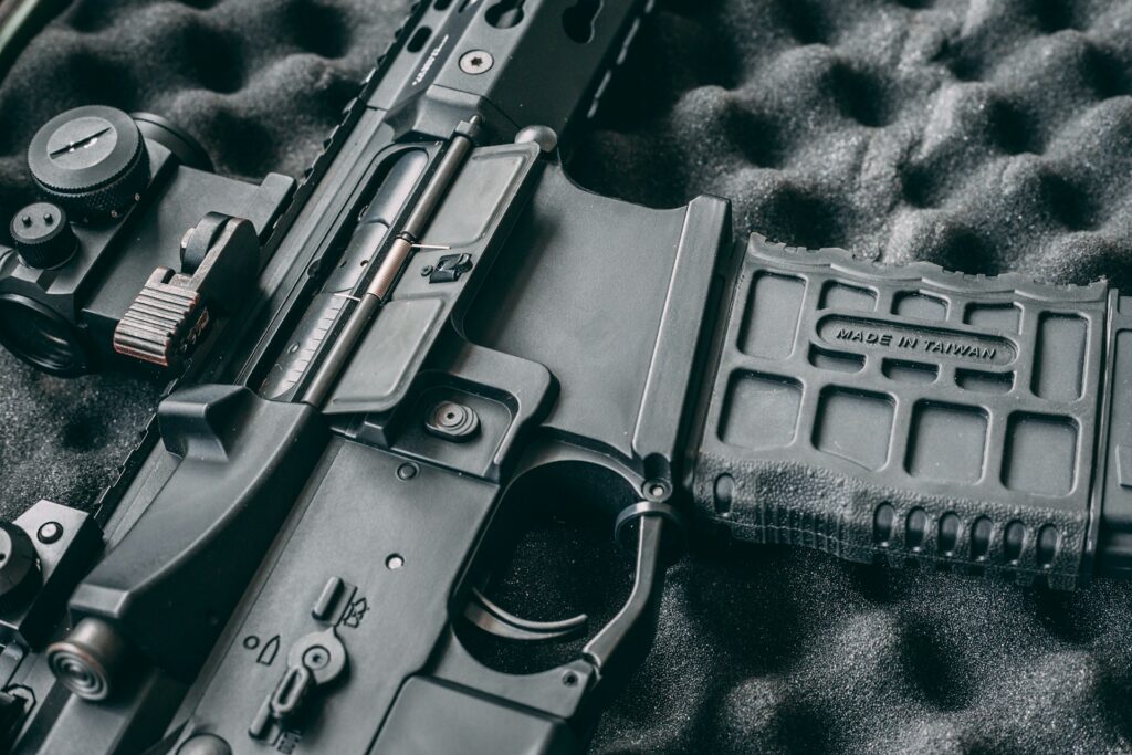 A close up of a black semi-automatic pistol against the gray, dimpled case interior, representing possession vs. carrying a weapon.